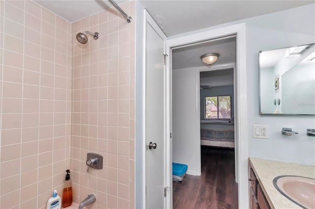 full bath featuring ensuite bath, shower / tub combination, wood finished floors, and vanity