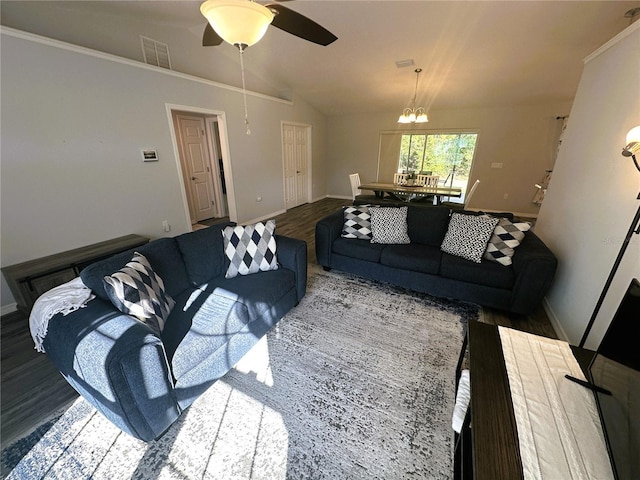 living room featuring lofted ceiling, visible vents, wood finished floors, baseboards, and ceiling fan with notable chandelier