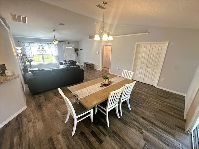 dining room featuring dark wood finished floors, visible vents, vaulted ceiling, and baseboards