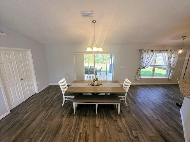 dining area with dark wood-style floors, baseboards, visible vents, and a notable chandelier