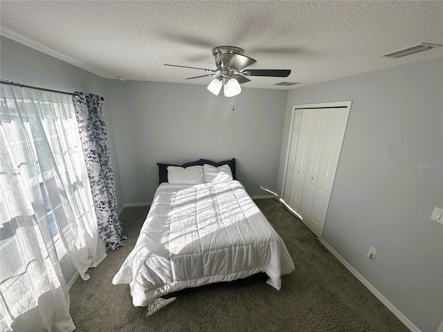 bedroom featuring carpet floors, a closet, visible vents, and ceiling fan