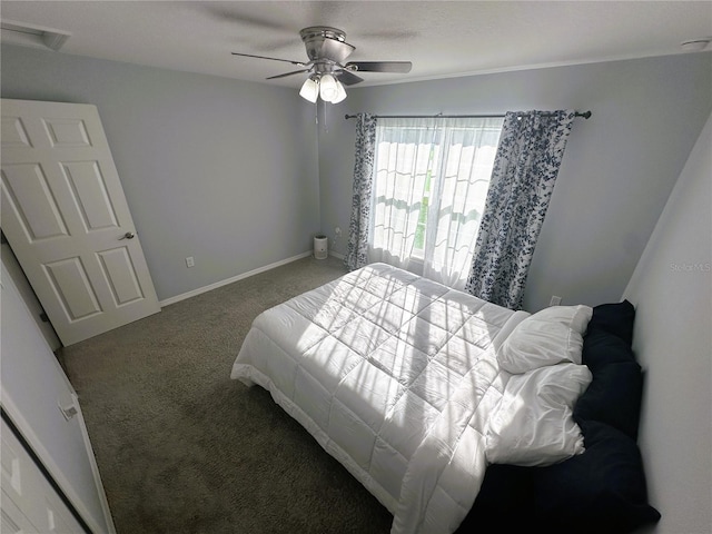 bedroom with a ceiling fan, carpet flooring, and baseboards