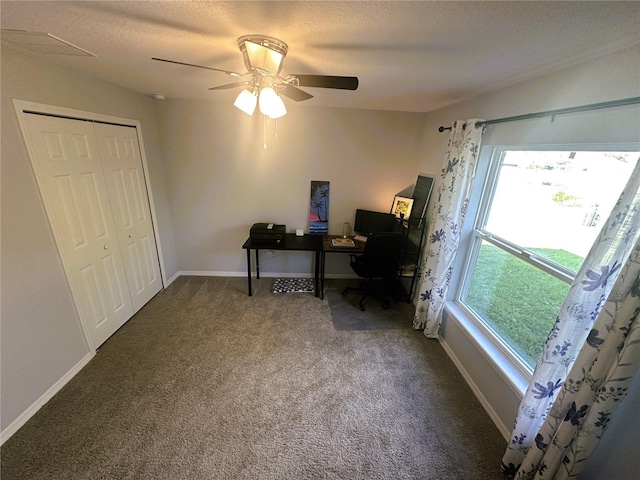 carpeted office with a ceiling fan, baseboards, and a textured ceiling