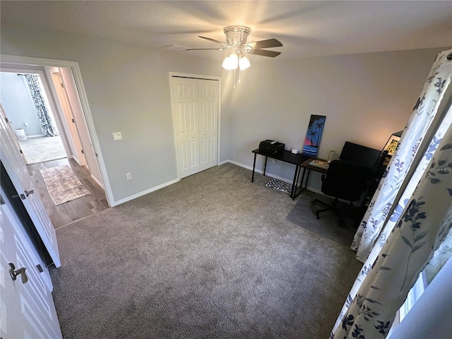 office space featuring carpet, baseboards, and a ceiling fan