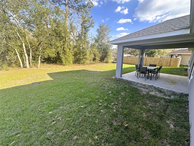 view of yard featuring fence and a patio