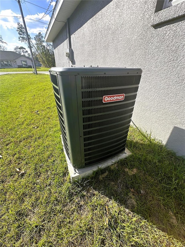 details featuring central AC unit and stucco siding