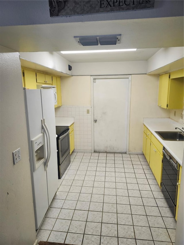 kitchen with electric range, white refrigerator with ice dispenser, a sink, black dishwasher, and light countertops