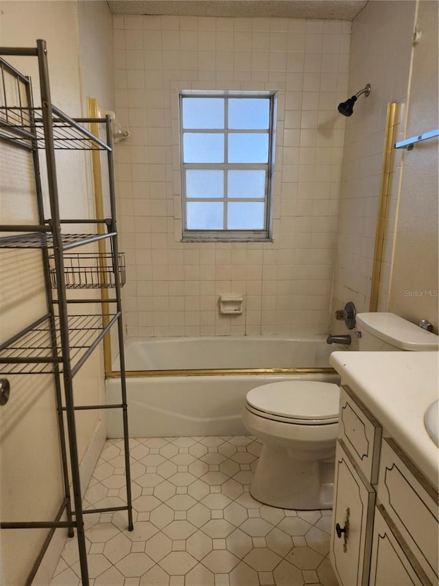 full bathroom featuring toilet, tile patterned floors, bathing tub / shower combination, and vanity