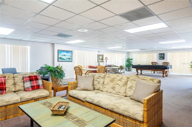 carpeted living area featuring a paneled ceiling