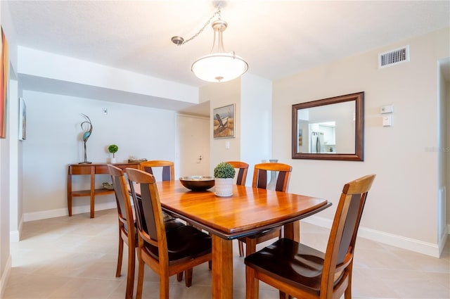 dining space featuring visible vents and baseboards