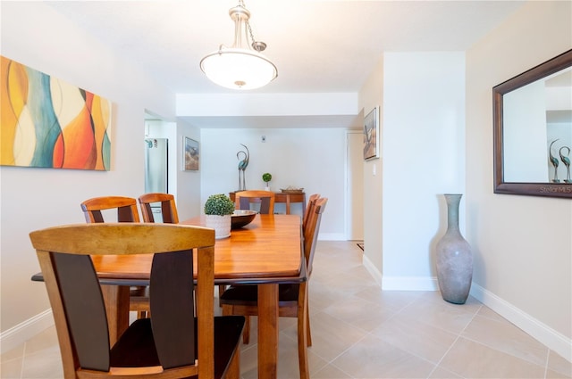 dining area with light tile patterned flooring and baseboards