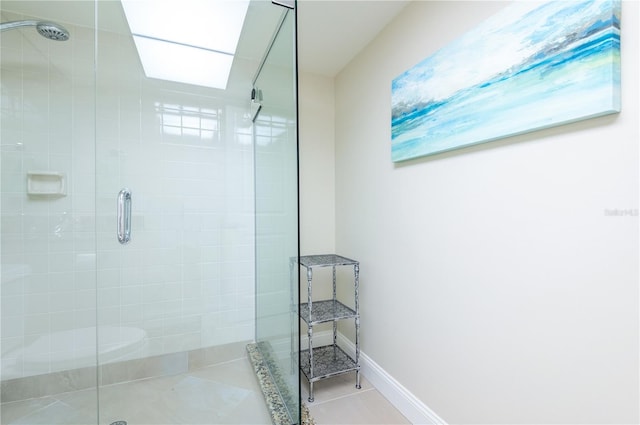 full bathroom with a shower stall, baseboards, and tile patterned floors