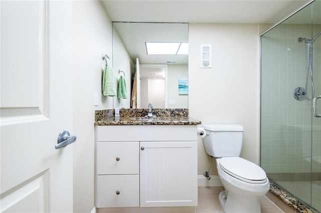 bathroom with visible vents, toilet, a stall shower, vanity, and tile patterned floors