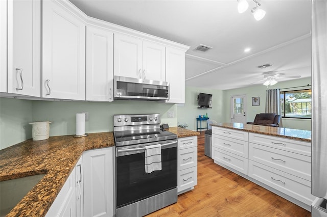 kitchen with light wood-style floors, visible vents, appliances with stainless steel finishes, and white cabinets