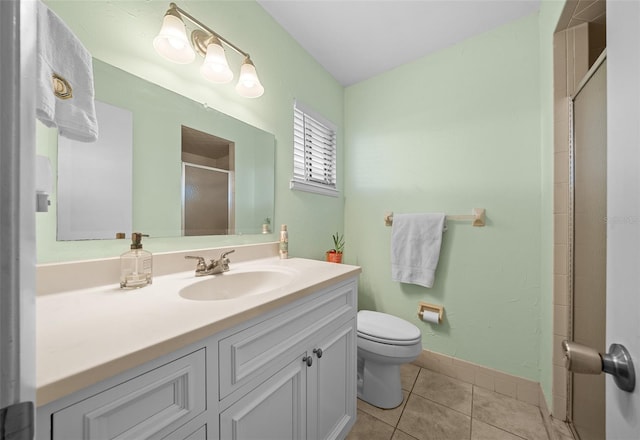 full bath with toilet, vanity, baseboards, tile patterned floors, and a stall shower