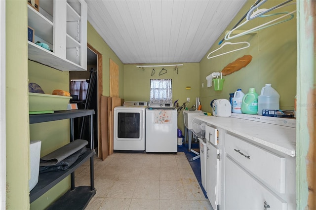 clothes washing area with light tile patterned floors, independent washer and dryer, cabinet space, and wood ceiling