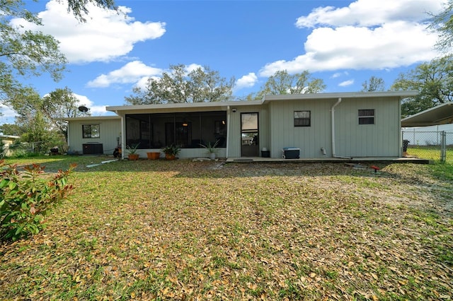 back of house with a sunroom, cooling unit, fence, and a lawn