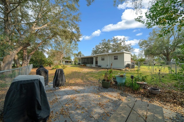 back of house with a gate, fence, a lawn, and a patio