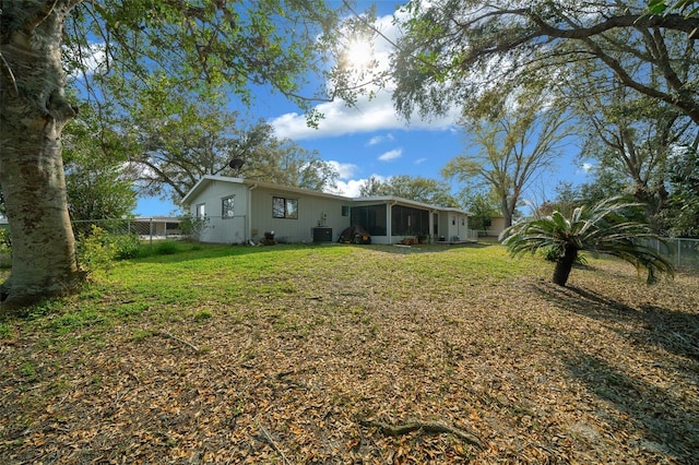 view of yard featuring a sunroom and fence