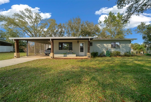 view of front of property with driveway, an attached carport, and a front lawn