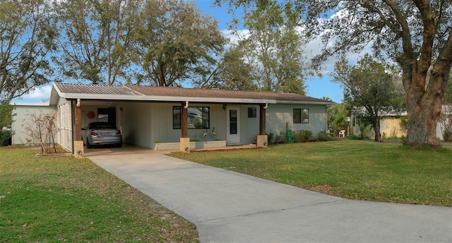 single story home with concrete driveway, an attached carport, and a front yard