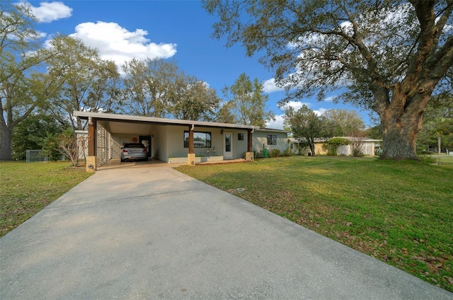 ranch-style house with a carport, concrete driveway, and a front yard