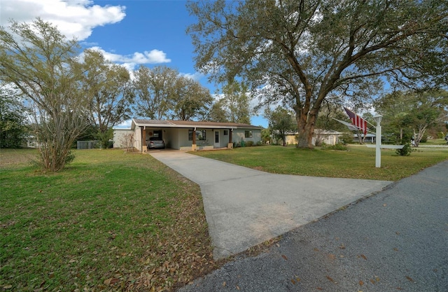 ranch-style house featuring driveway, a front lawn, and an attached carport