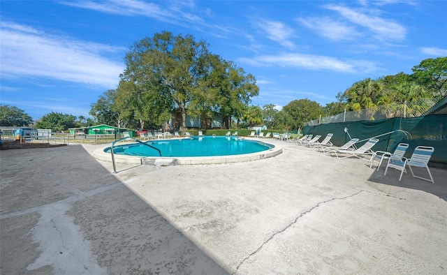 pool featuring a patio and fence