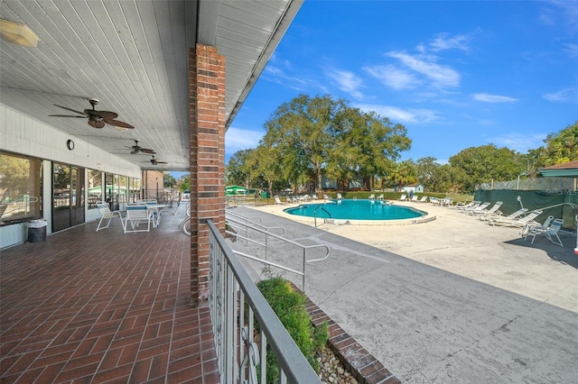 pool with a ceiling fan, a patio, and fence