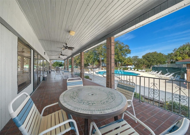 view of patio featuring ceiling fan and a community pool