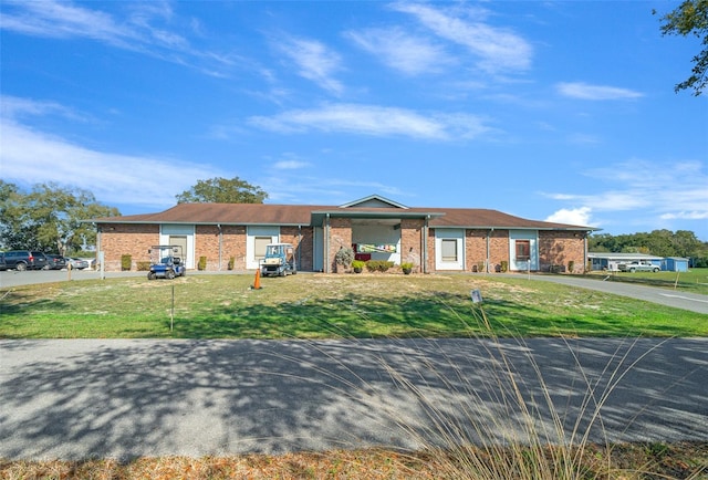 view of front facade with a front lawn and brick siding