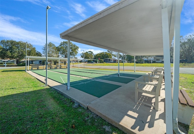 view of home's community featuring a lawn and shuffleboard