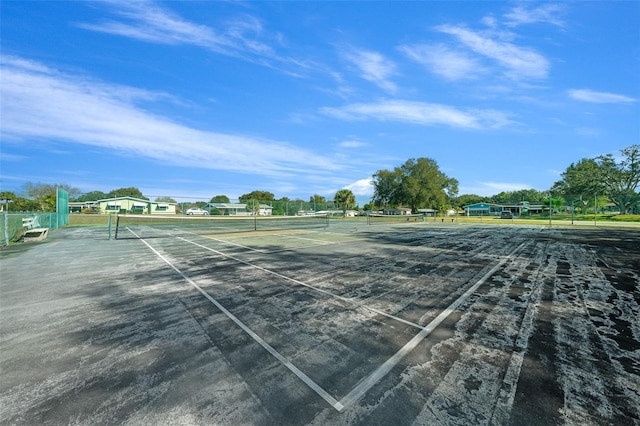 view of tennis court with fence