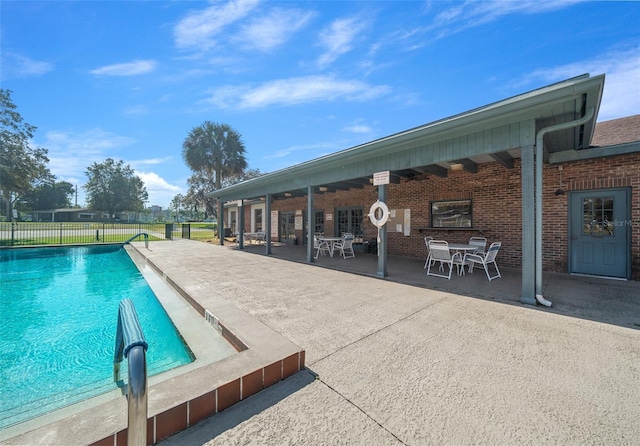 view of pool with fence, a fenced in pool, and a patio