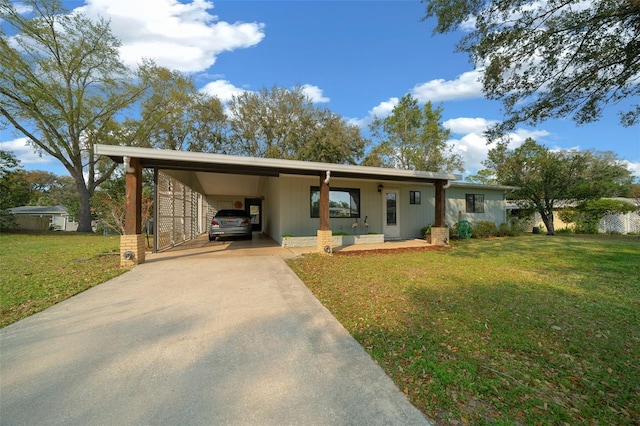 single story home with an attached carport, a front lawn, and concrete driveway