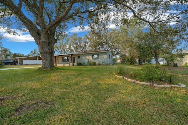 single story home featuring a front lawn