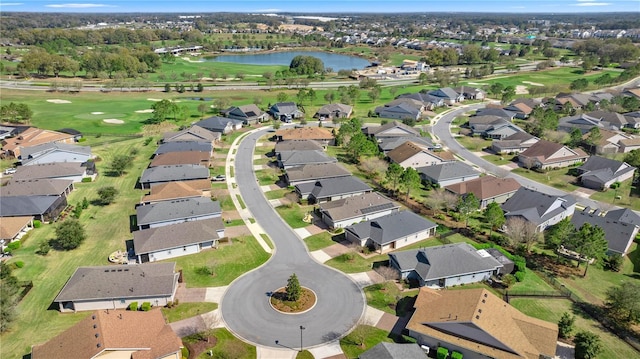 drone / aerial view with view of golf course, a water view, and a residential view