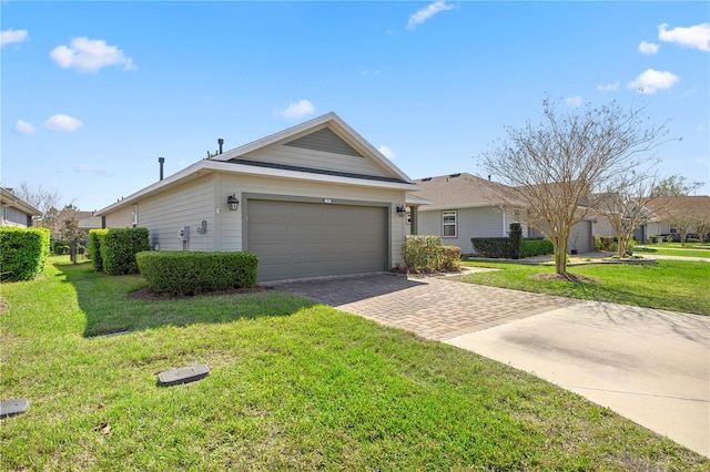 single story home with an attached garage, decorative driveway, and a front yard