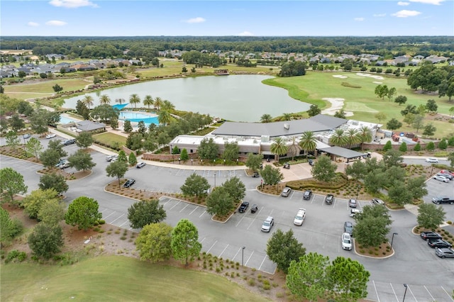 birds eye view of property with view of golf course and a water view