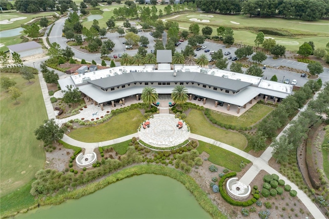 drone / aerial view featuring view of golf course and a water view