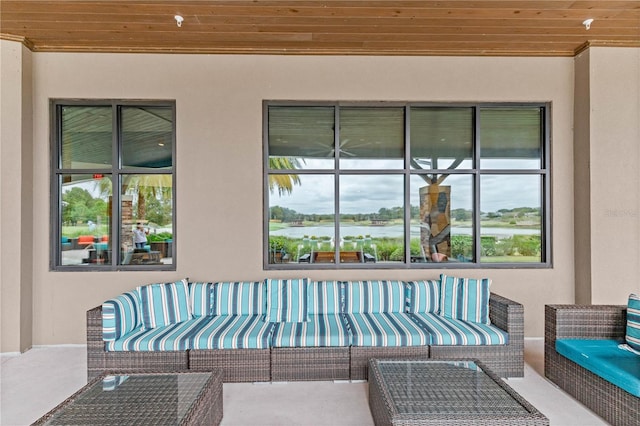 view of patio featuring a water view and an outdoor living space