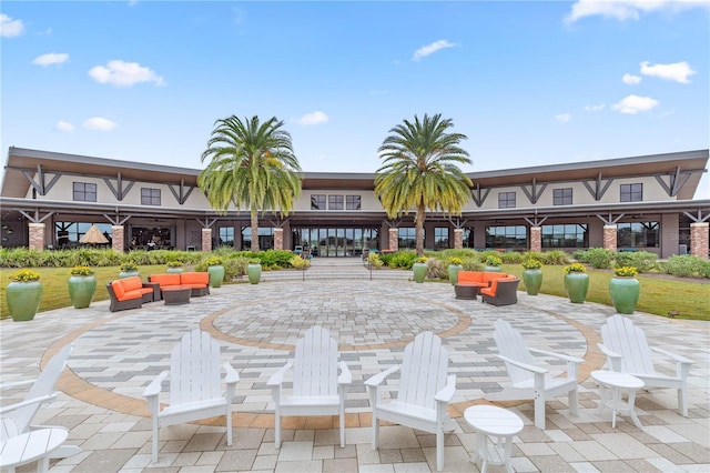 view of property's community with a patio area and an outdoor living space