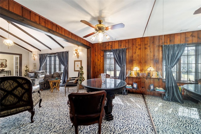 dining room with vaulted ceiling with beams, ceiling fan, visible vents, and wooden walls