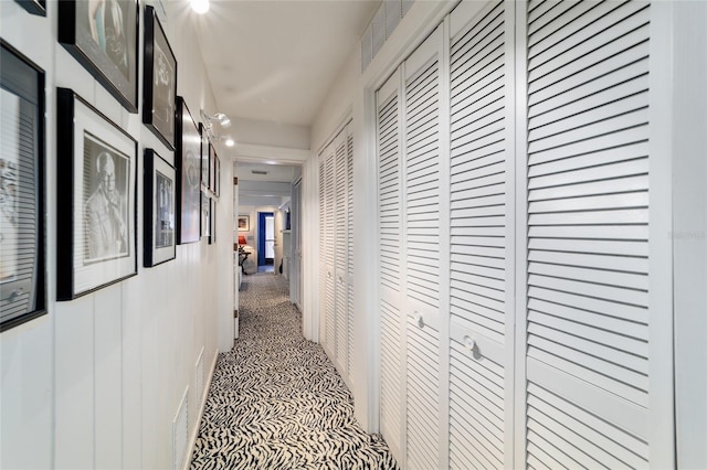 corridor featuring carpet flooring and visible vents