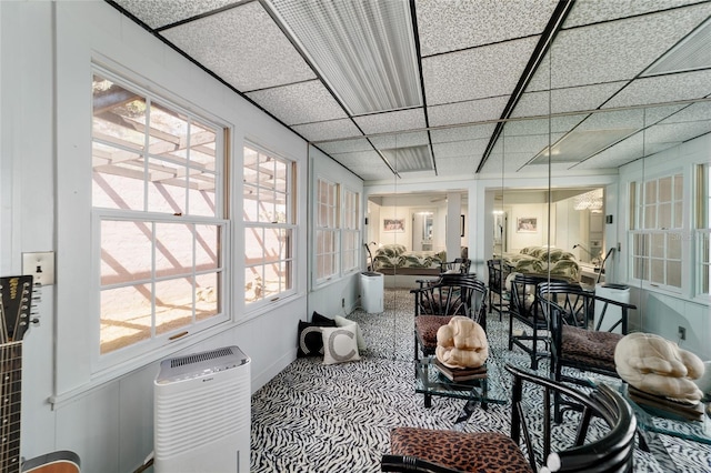 sunroom / solarium with a paneled ceiling