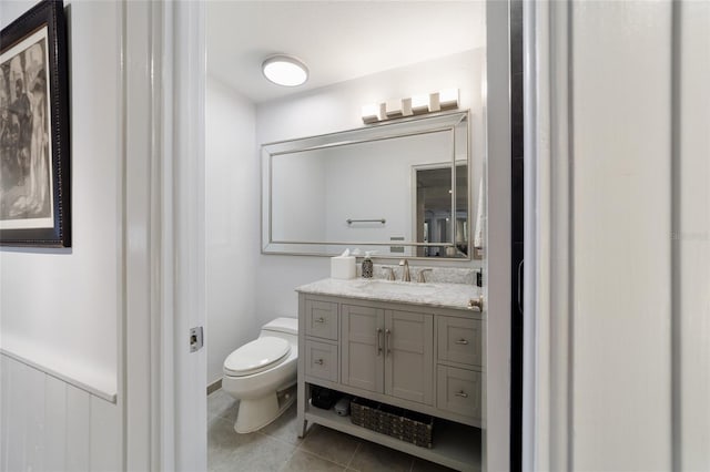 bathroom with vanity, toilet, and tile patterned floors