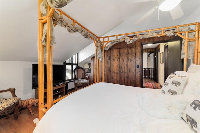 bedroom featuring lofted ceiling and wood finished floors