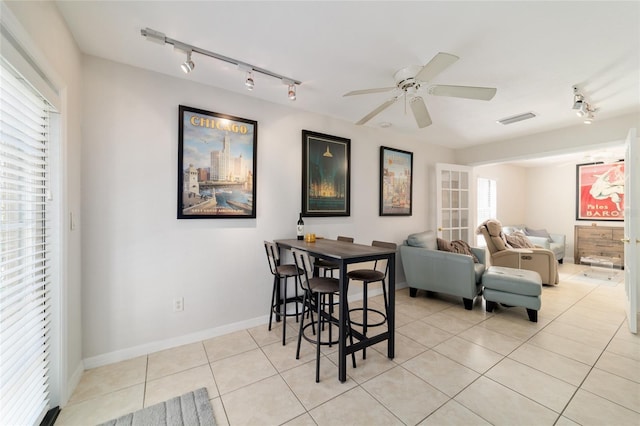 dining space with baseboards, visible vents, a ceiling fan, track lighting, and light tile patterned flooring