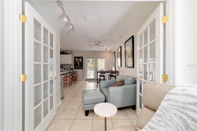 interior space featuring light tile patterned floors, ceiling fan, visible vents, french doors, and track lighting