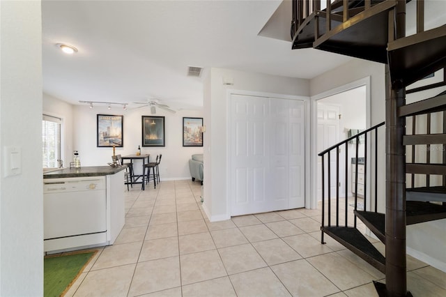 foyer entrance with light tile patterned floors, ceiling fan, stairway, and visible vents